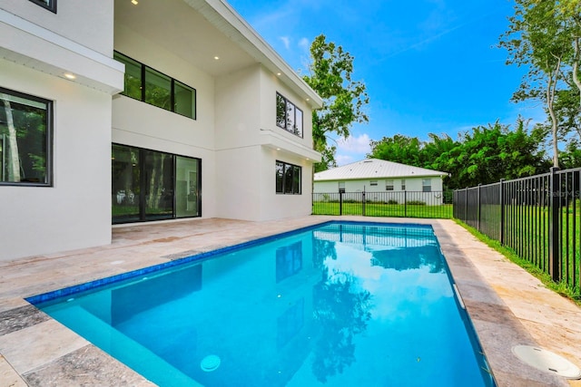 view of pool with a lawn and a patio area