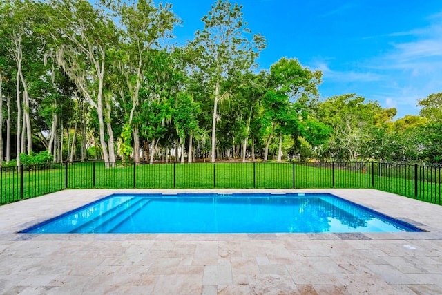 view of swimming pool with a lawn