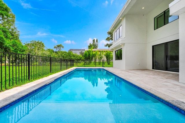 view of swimming pool with a patio area