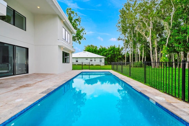 view of swimming pool featuring a lawn and a patio area