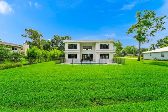 back of property with a patio and a yard