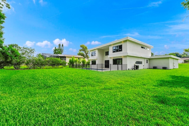 rear view of house featuring a lawn