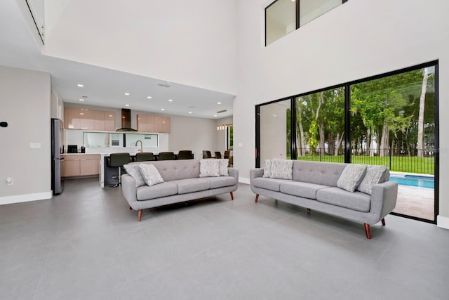 tiled living room featuring plenty of natural light and sink