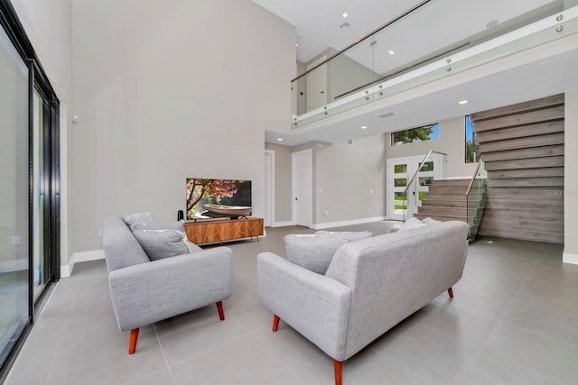 tiled living room featuring a high ceiling