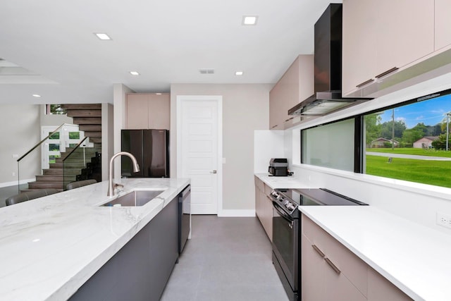 kitchen with black fridge, wall chimney exhaust hood, range with electric cooktop, sink, and dishwasher