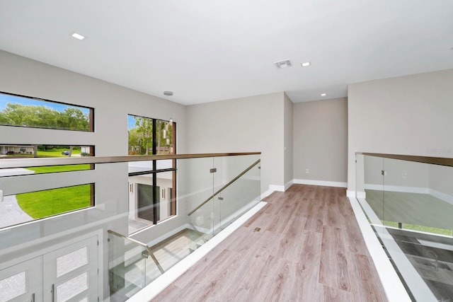 corridor with light hardwood / wood-style floors