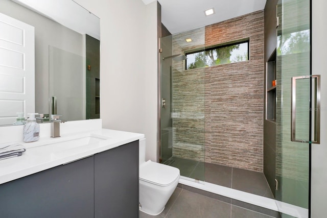 bathroom with tile flooring, a shower with shower door, toilet, and vanity