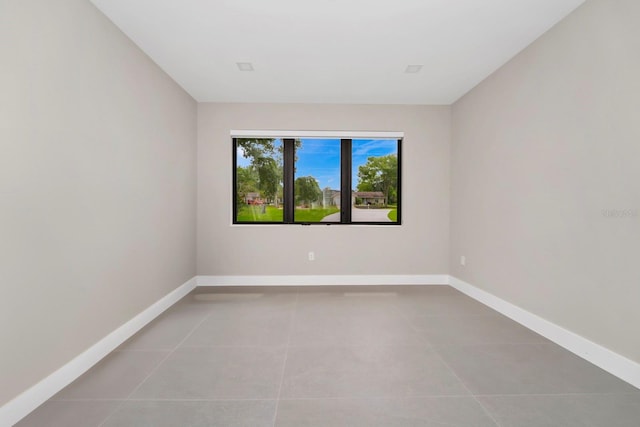 spare room with tile floors