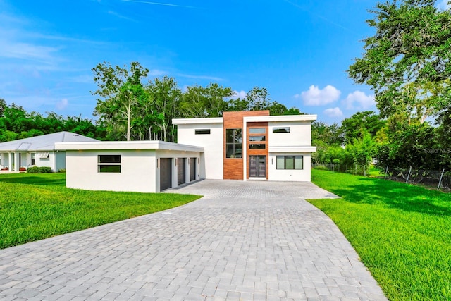 contemporary home with a garage and a front yard