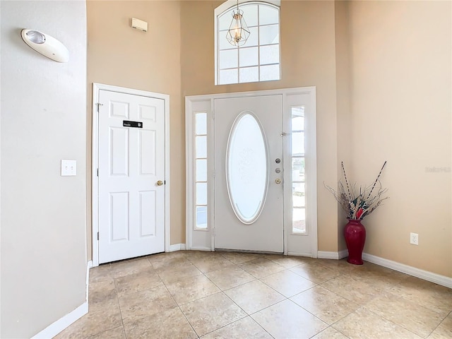 tiled foyer with plenty of natural light and a towering ceiling