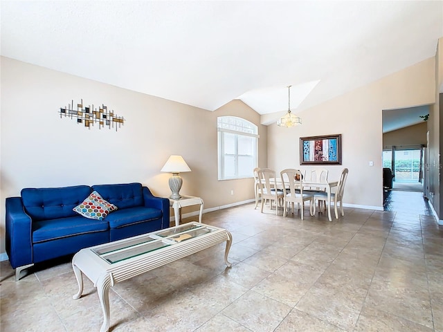 living room featuring a notable chandelier, tile flooring, and lofted ceiling