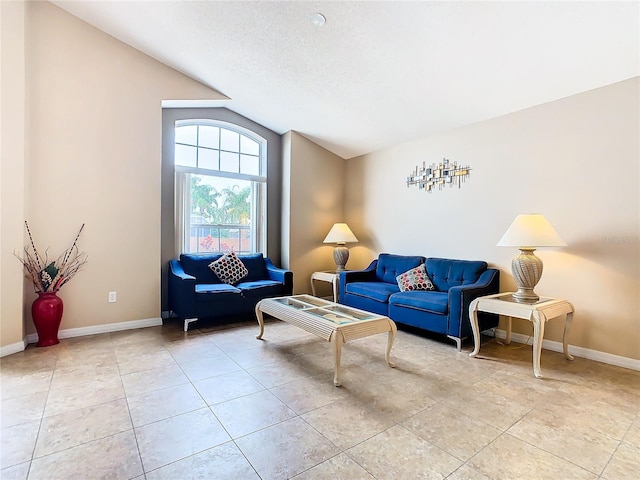 tiled living room with vaulted ceiling and a textured ceiling