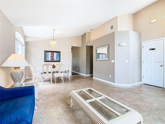 living room featuring tile flooring and vaulted ceiling