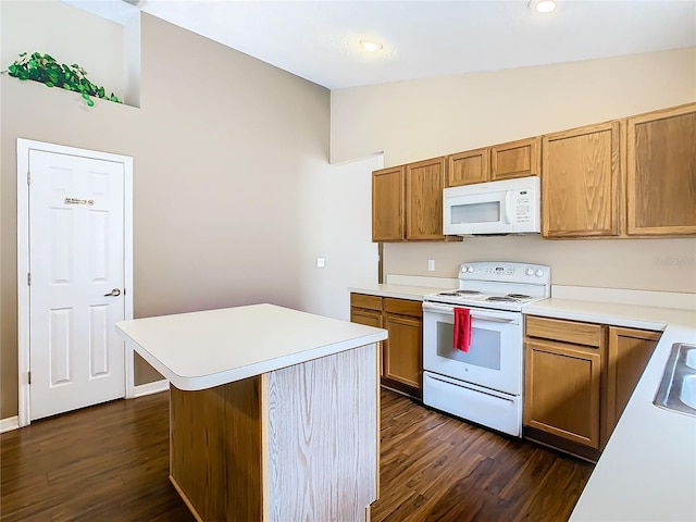 kitchen featuring a kitchen island, dark hardwood / wood-style flooring, white appliances, sink, and vaulted ceiling