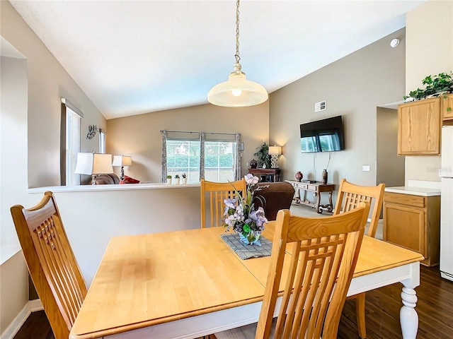 dining space with dark hardwood / wood-style flooring and lofted ceiling