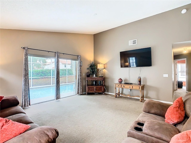 carpeted living room featuring vaulted ceiling