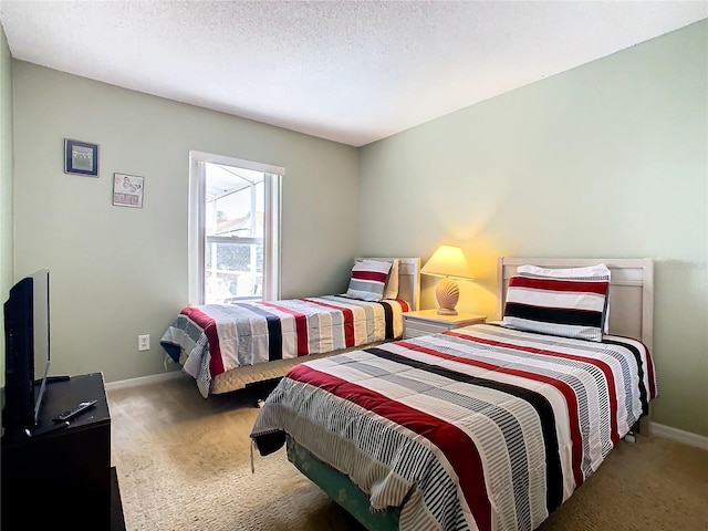 bedroom with a textured ceiling and carpet flooring