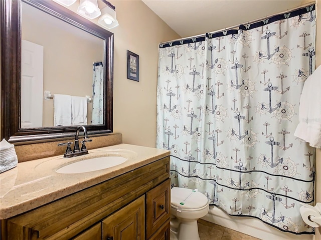 bathroom with tile floors, toilet, and vanity with extensive cabinet space