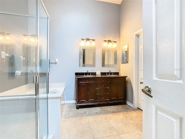 bathroom with dual bowl vanity, tile flooring, and separate shower and tub