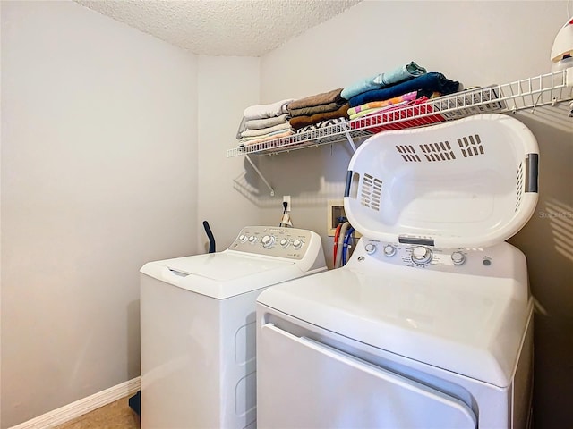 clothes washing area with washer hookup, washer and dryer, and a textured ceiling