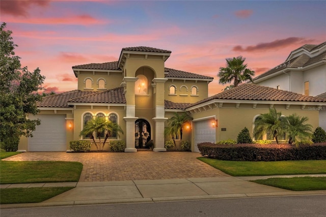 mediterranean / spanish home featuring a garage