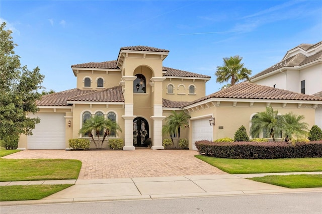 mediterranean / spanish home with a garage