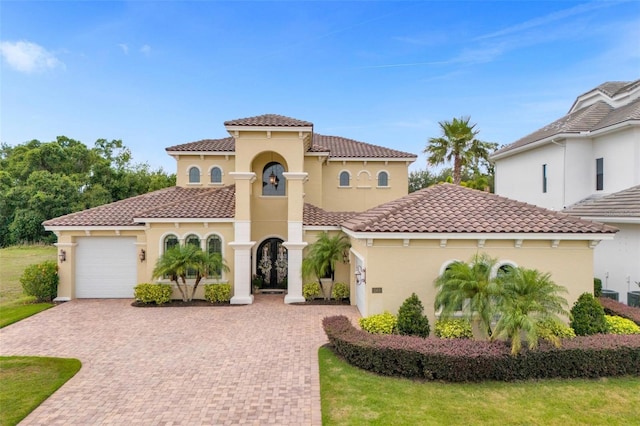 mediterranean / spanish house with a garage