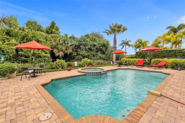 view of pool featuring an in ground hot tub and a patio area