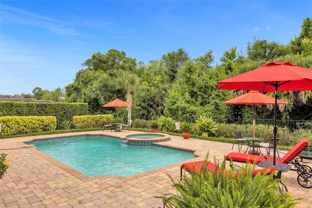 view of pool featuring an in ground hot tub and a patio