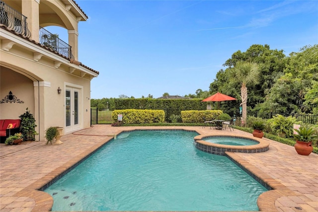 view of swimming pool with an in ground hot tub, french doors, and a patio