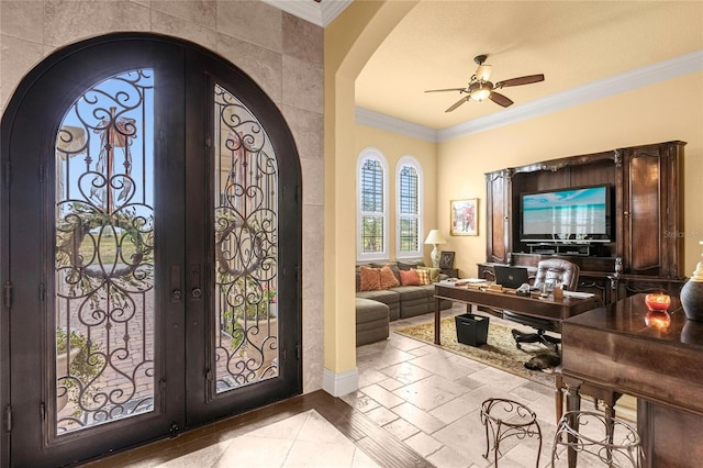 entrance foyer featuring ceiling fan, crown molding, and french doors