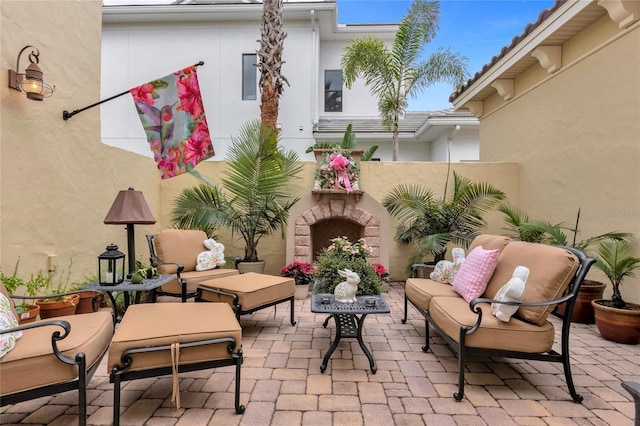 view of patio with an outdoor living space with a fireplace