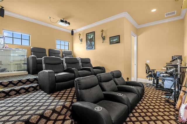 cinema room featuring ornamental molding and carpet floors