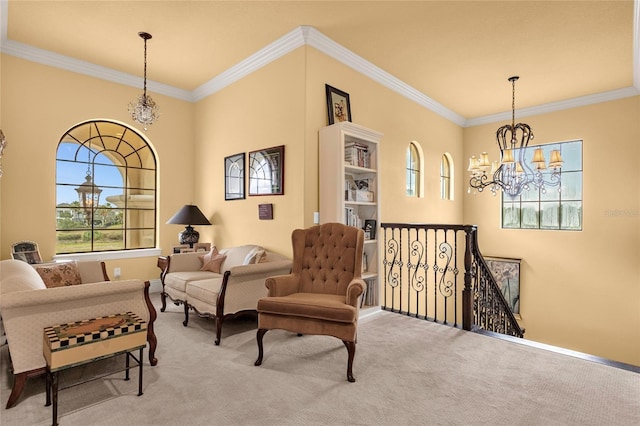 sitting room featuring crown molding, carpet floors, and a notable chandelier