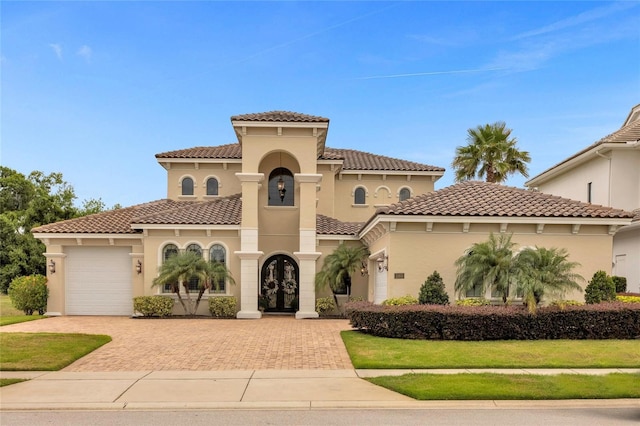 mediterranean / spanish house featuring a garage