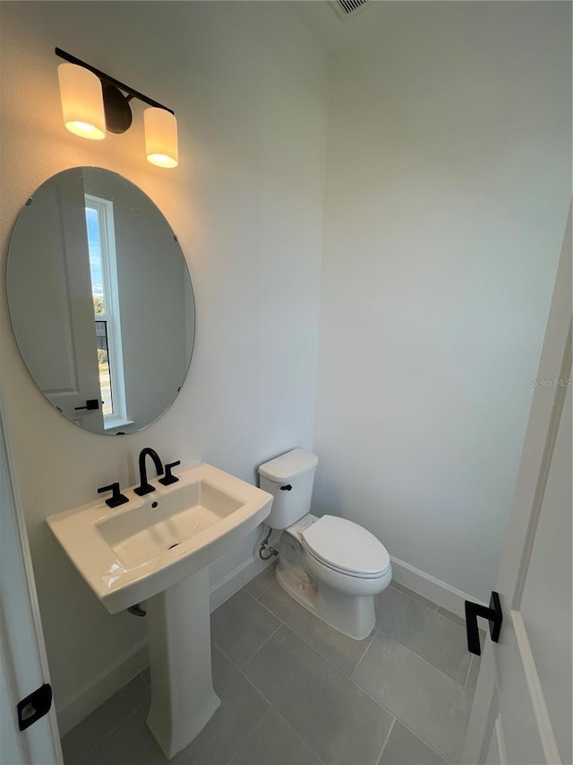 bathroom with tile patterned floors and toilet