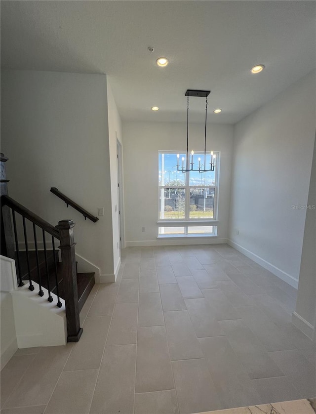 unfurnished dining area with a chandelier