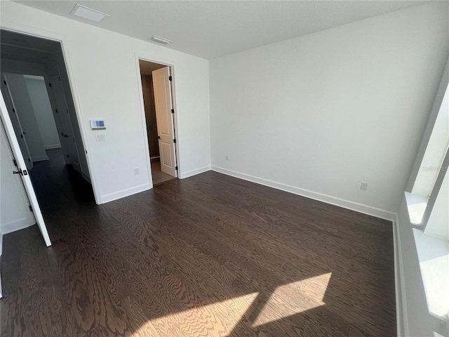 unfurnished bedroom with dark wood-type flooring