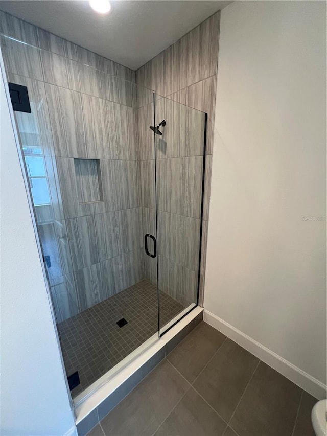 bathroom featuring walk in shower and tile patterned floors