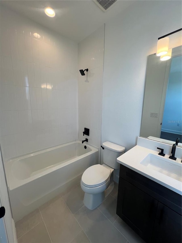 full bathroom with tiled shower / bath, vanity, toilet, and tile patterned flooring