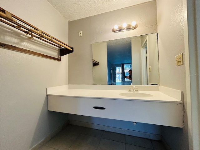 bathroom featuring tile patterned floors, vanity, and a textured ceiling