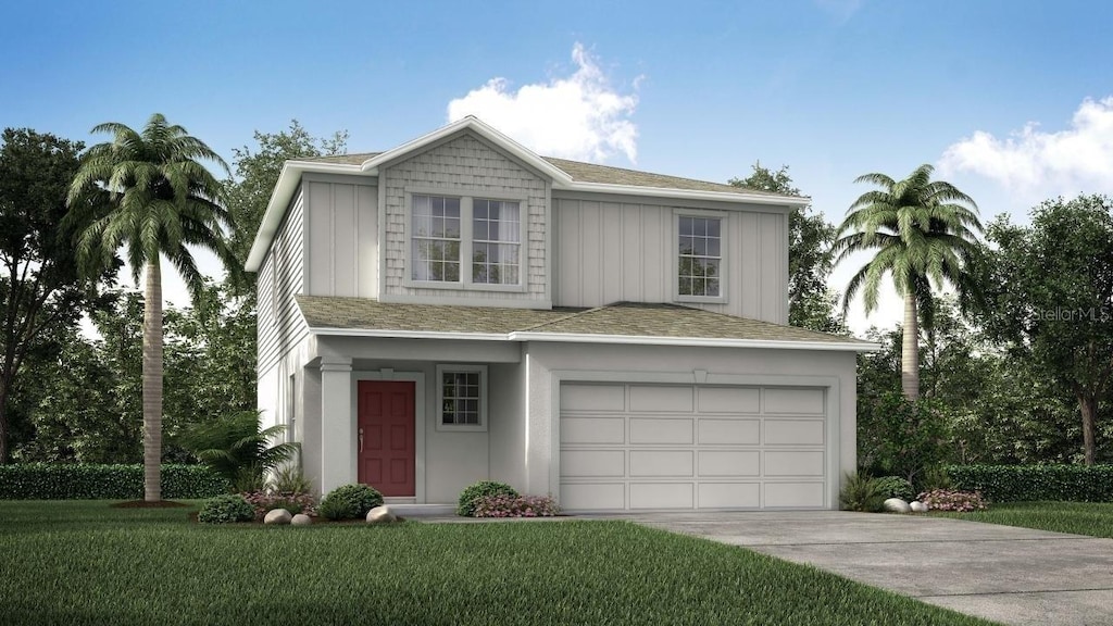 view of front of property with a garage and a front yard