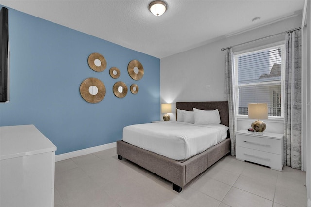 bedroom with light tile patterned floors and a textured ceiling