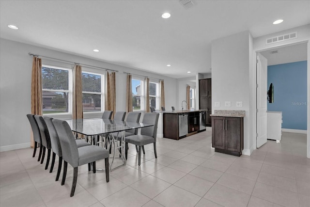 tiled dining room featuring sink