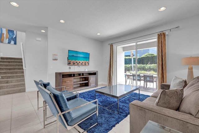 living room featuring a textured ceiling and light tile patterned flooring