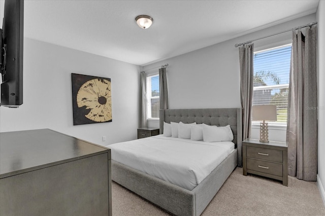 bedroom featuring light colored carpet