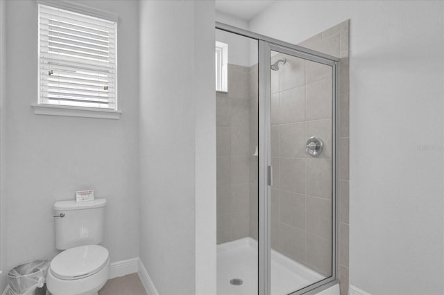 bathroom featuring an enclosed shower and toilet