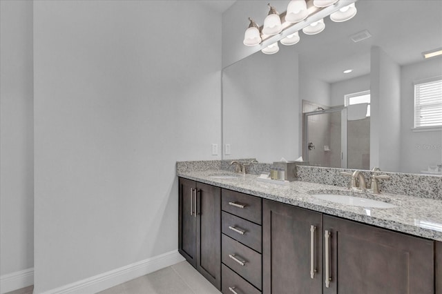 bathroom with tile patterned flooring, vanity, and walk in shower