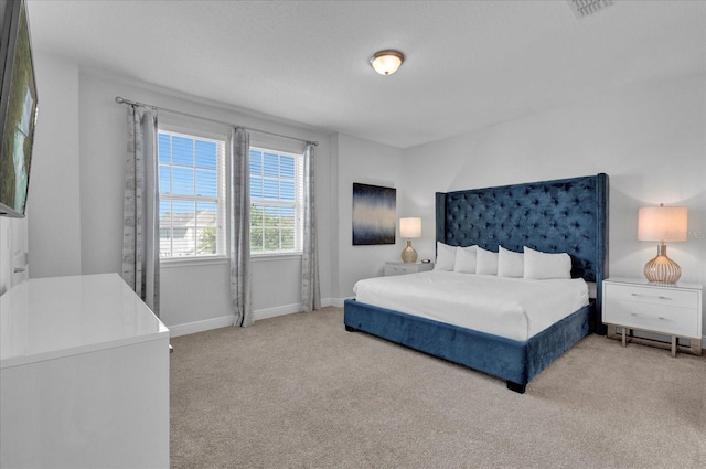 bedroom with light colored carpet