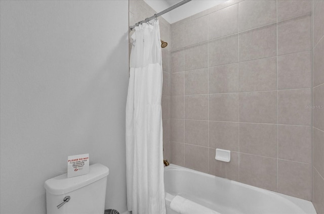 bathroom featuring shower / bathtub combination with curtain and toilet